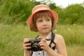 Child, kid portrait photographer a little girl with a camera on the background of nature. Royalty Free Stock Photo