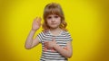 Child kid swear to be honest, aising hand to take oath promising to tell truth keeping hand on chest