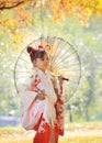 Child in kimono with umbrella