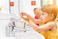 Child in kindergarten washing her hands