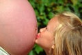 Child kissing pregnant belly Royalty Free Stock Photo