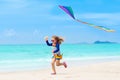 Child with kite. Kids play. Family beach vacation. Royalty Free Stock Photo