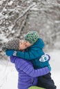 A child in a knitted hat kisses his mother Royalty Free Stock Photo