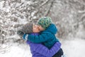 A child in a knitted hat kisses his mother Royalty Free Stock Photo