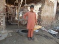 Child Labour - Young boy working in Small village business place for gathering waste material in Pakistan