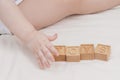 The child laid out the word toys made of wooden cubes, close-up. A small child learns the English alphabet, learns to Royalty Free Stock Photo