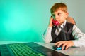 A child at a laptop in the office agrees on matters by wire, the concept of modern children`s business Royalty Free Stock Photo