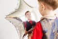 Child laughing looking at the reflection in a distorted mirror Royalty Free Stock Photo