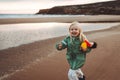 Child laughing running on the beach girl playing outdoor family lifestyle vacations 4 years old kid Royalty Free Stock Photo