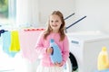 Child in laundry room with washing machine Royalty Free Stock Photo