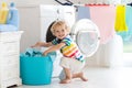 Child in laundry room with washing machine Royalty Free Stock Photo