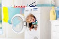 Child in laundry room with washing machine Royalty Free Stock Photo