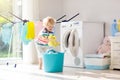 Child in laundry room with washing machine Royalty Free Stock Photo