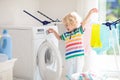 Child in laundry room with washing machine Royalty Free Stock Photo