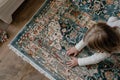 child laying a patterned area rug