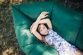 A child lays on a resting on an air sofa in the forest. Lamzac. Travel, family vacation in the forest in summer Royalty Free Stock Photo
