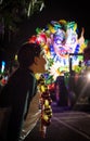 A Child Waits for Parade Throws During the Orpheus Parade