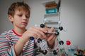 Child learning chemistry, making model of a molecule, engineering and STEM