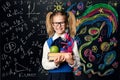 Child Learning Creativity and Mathematics, Creative School Kid Girl Student with Books over Art Blackboard Royalty Free Stock Photo