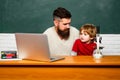 Child learning. Daddy and son together. Teacher and schoolboy using laptop in class. Back to school and Education