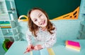 Child learning. Fun child girl in classroom near blackboard desk. School education and people concept - cute pupil over Royalty Free Stock Photo