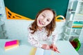 Child learning. Fun child girl in classroom near blackboard desk. School education and people concept - cute pupil over Royalty Free Stock Photo