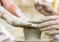 Child learning how to make a pot, old potter h