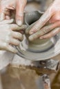 Child learning how to make a pot, old potter h