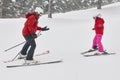 Child learning how to ski with an instructor. Winter