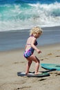 Child learning how to skimboard in Laguna Beach, CA