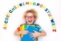 Child learning letters of alphabet and reading Royalty Free Stock Photo