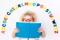 Child learning letters of alphabet and reading Royalty Free Stock Photo