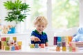 Child learning letters. Kid with wooden abc blocks