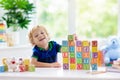 Child learning letters. Kid with wooden abc blocks Royalty Free Stock Photo