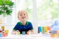 Child learning letters. Kid with wooden abc blocks