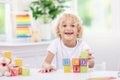 Child learning letters. Kid with wooden abc blocks Royalty Free Stock Photo