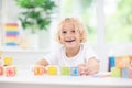 Child learning letters. Kid with wooden abc blocks Royalty Free Stock Photo