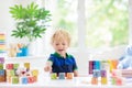 Child learning letters. Kid with wooden abc blocks Royalty Free Stock Photo