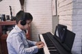 Child learning piano online lessons in quarantine . Coronavirus life style