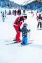 The child learning to ski and man on the slope in Bansko, Bulgaria