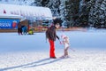 The child learning to ski and man on the slope