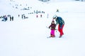 The child learning to ski and man on the slope