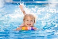 Child learning to swim. Kids in swimming pool Royalty Free Stock Photo