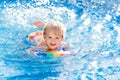 Child learning to swim. Kids in swimming pool Royalty Free Stock Photo