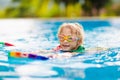 Child learning to swim. Kids in swimming pool Royalty Free Stock Photo