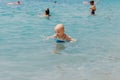 Child learning to swim in the open sea of tropical resort. Kids learn swimming. Exercise and training for young children