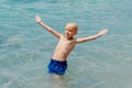 Child learning to swim in the open sea of tropical resort. Kids learn swimming. Exercise and training for young children