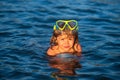 Child learning to swim in outdoor. Little kid boy at beach during summer vacation. Royalty Free Stock Photo
