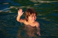 Child learning to swim in outdoor. Little kid boy at beach during summer vacation. Summer vacation and travel concept. Royalty Free Stock Photo