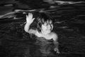 Child learning to swim in outdoor. Little kid boy at beach during summer vacation. Summer vacation and travel concept. Royalty Free Stock Photo